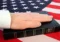 photo of hand on Bible placed on an American flag